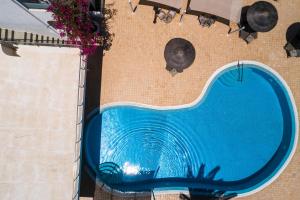 an overhead view of a swimming pool on a building at Smaragdi in Perivolos