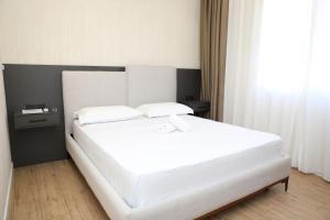 Postel nebo postele na pokoji v ubytování Hotel Scutari