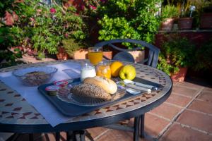 a table with a tray of food and orange juice at Hotel La Peña in Tarifa
