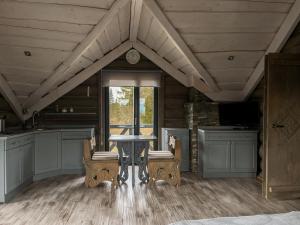 a kitchen with a table and chairs and a window at Charlton Estate in Yablunytsya