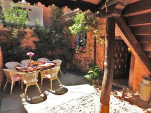 a patio with a table and chairs in a building at La Casa De Murias in Murias de Rechivaldo
