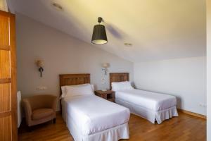 Łóżko lub łóżka w pokoju w obiekcie Casa dos Maza