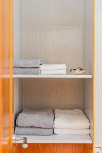 a shelf with towels and towels in a bathroom at Titi's Villa in Durrës