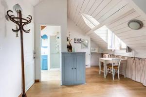 a living room with a table and a blue cabinet at Grande Chambre équipée dans maison Bauloise proche mer kitch sde wc lit 160 in La Baule