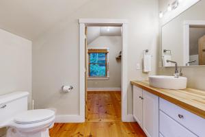 a bathroom with a white toilet and a sink at Muscongus Sound Lookout in Round Pond