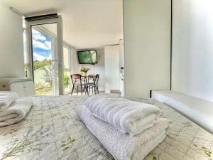 a bedroom with a bed with towels on it at Studio Katara Brela in Brela
