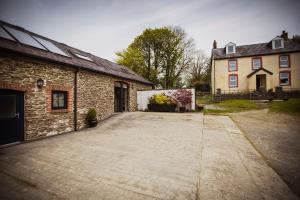 a large driveway in front of a brick building at Siramik in Carmarthen