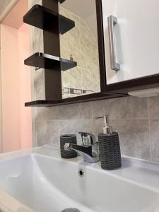 a bathroom sink with a faucet and a mirror at Villa Sunny side Sarajevo in Sarajevo