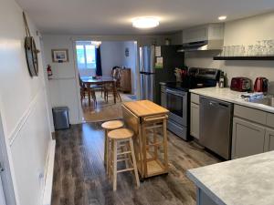 a kitchen with a table and stools in it at Harbour House Twillingate in Twillingate