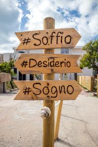 a wooden sign that says santa sabina and destination at Il Soffione in Castelsardo +32 photos