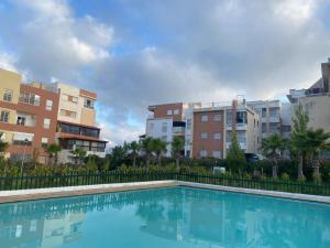 a swimming pool in front of some buildings at Appart Tanger Beach in Tangier