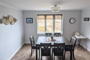 a dining room with a table and chairs and a window at On the Rocks Overlooking the Sea in Twillingate