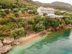 an aerial view of a resort on a hill with a beach at Oceanis Rooms Apartments in Barbati