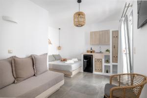 a living room with a couch and a kitchen at Naxos Seahouse in Naxos Chora