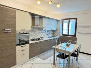 a kitchen with a table and a dining room at Family Stylish Apartment in Norcia