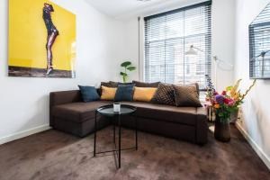 a living room with a couch and a table at Luxurious boutique suite in City Center in Amsterdam