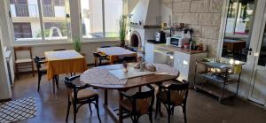 a room with a table and chairs and a kitchen at Palute in Supetar