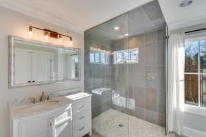 a bathroom with a shower and a sink and a mirror at Modern Clarkesville Cottage with Decks and Patio! in Lakemont