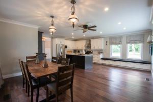 a kitchen and dining room with a wooden table at Deer Run Cottage- Golf Course cottage in Kawartha Lakes