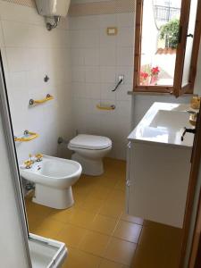 a bathroom with a toilet and a sink at La casina - Castiglioncello in Castiglioncello +41 photos