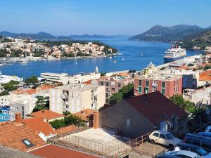 a view of a city with a cruise ship in the water at Guesthouse Gravosa in Dubrovnik