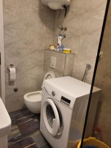 a bathroom with a washing machine and a toilet at Guesthouse Gravosa in Dubrovnik