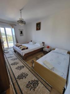 a bedroom with two beds and a chandelier at Guesthouse Gravosa in Dubrovnik