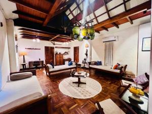 a living room with couches and a table at Svarna in Udupi