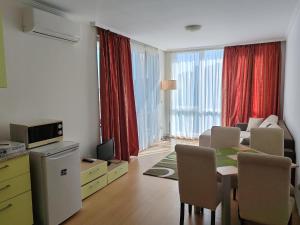 a living room with a kitchen and a dining room at Kabakum Apartments in Golden Sands