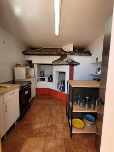 a kitchen with a stove and a stove top oven at Sunset Paradise Villa with Heated Pool in Calheta +88 photos