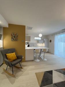 a living room with a chair and a table at La Villa du Soleil in Saint-Cyprien