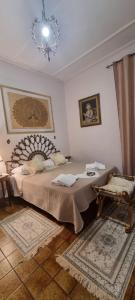 a bedroom with a large bed and a chandelier at Enza Domus in Bari