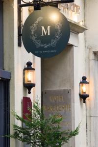 a sign on the side of a hotel marguerite at Hôtel Marguerite in Orléans