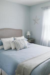 una camera bianca con letto e cuscini bianchi di Etoile bleue Beach bike shops Magog-Orford a Magog-Orford
