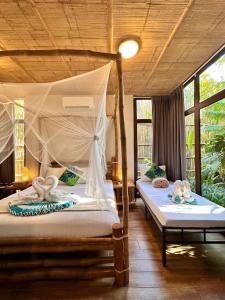 a bedroom with two beds in a room at Buko Beach Resort in El Nido +105 photos