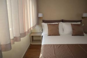 Postel nebo postele na pokoji v ubytování Quarto di Monte Suite & Spa
