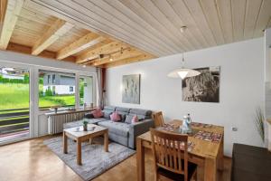 a living room with a couch and a table at Almglück in Steibis in Oberstaufen