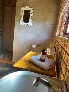 a bathroom with a sink and a bath tub at Soetgeluk Farm Cottage in Hekpoort +20 photos