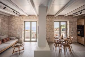 a living room with a couch and a table at Villa Yiannis in Xirokástellon