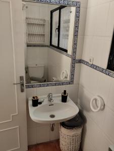 a bathroom with a sink and a mirror at Villa Jade Beach in Cala del Moral +23 photos