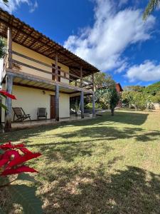 an outside view of a house with a grass yard at Pousada Maruru in Serra do Cipo +65 photos