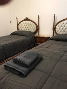 two beds sitting next to each other in a bedroom at Departamento de categoría in Ramos Mejía
