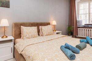 a bedroom with a large bed with two blue towels on it at Old Town Private Room, Shared Bath - D in Tallinn