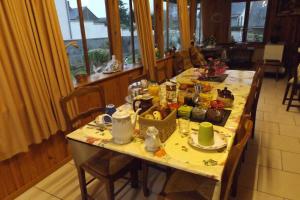 a long table with food on it in a room at Chambres Les Salles in Beauvoir