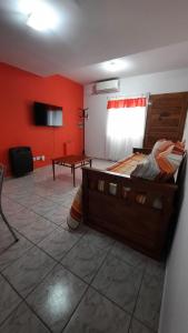 a bedroom with a large bed and red walls at Mi Rincon in San Rafael