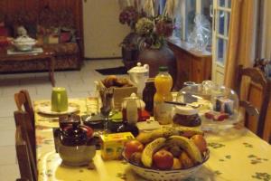 a table with a bowl of fruit on it at Chambres Les Salles in Beauvoir