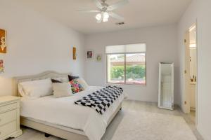 a white bedroom with a bed and a ceiling fan at Pet-Friendly Indio Home with Hot Tub 55 and Community in Indio +25 photos