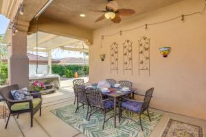 a dining area with a table and chairs on a patio at Pet-Friendly Indio Home with Hot Tub 55 and Community in Indio