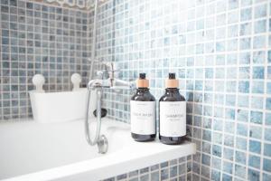 two bottles of wine sitting on a shelf in a bathroom at El Balcón del Guadalhorce in Alora +17 photos