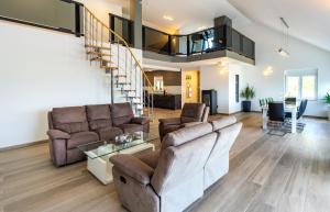 a living room with two couches and a staircase at Villa Wild Rose in Imotski